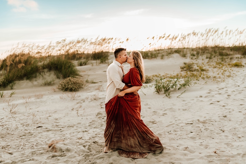 Family and Maternity Photographer, a husband and wife kiss on the beach