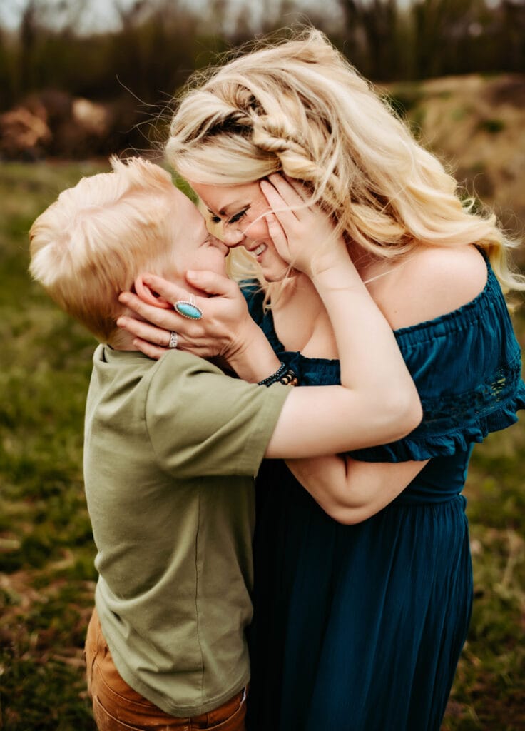 Family Photographer, a mother and her son embrace outside, face to face.
